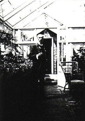 Waterhouse standing inside a conservatory